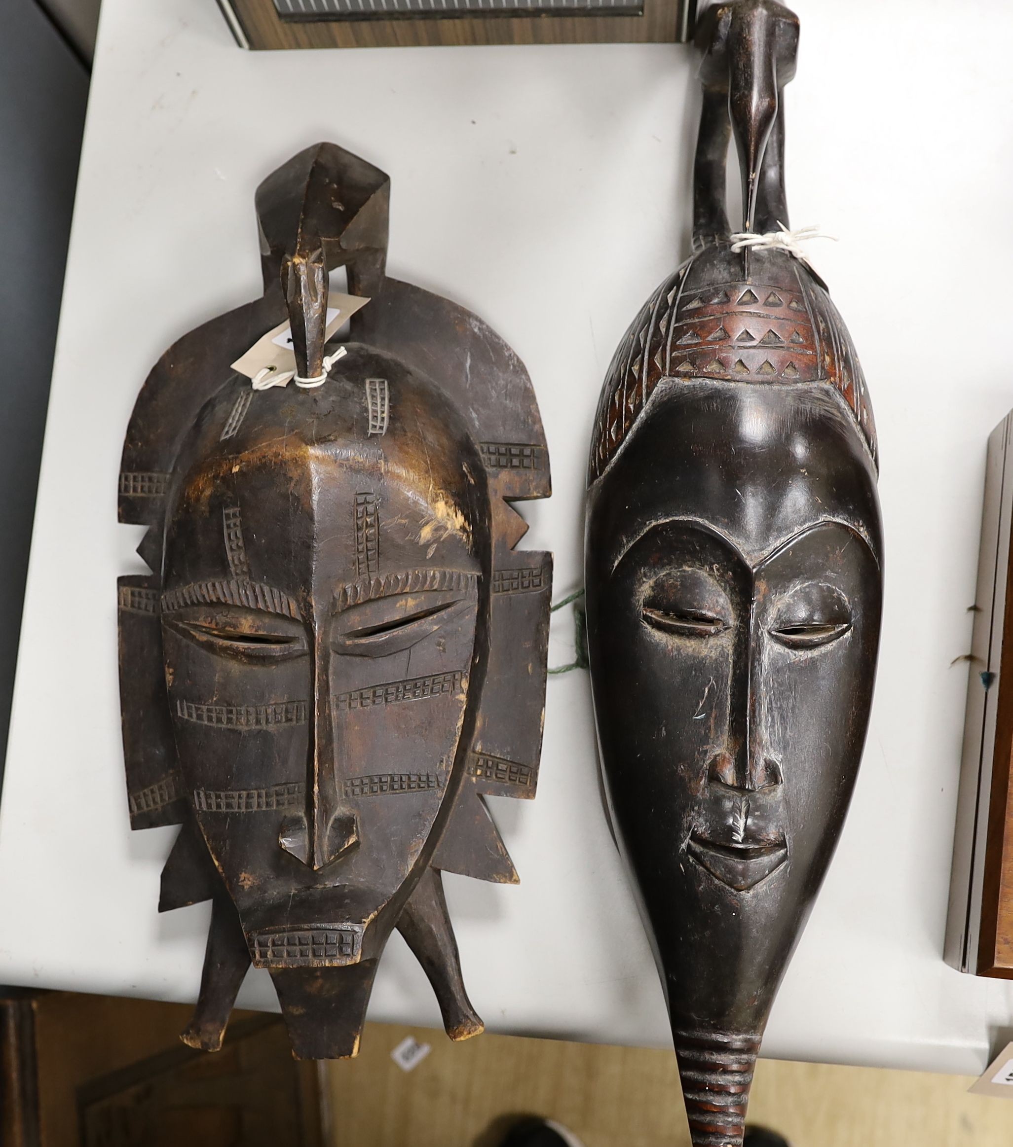 Two African carved wood masks; Senufo and Baule 65cm
